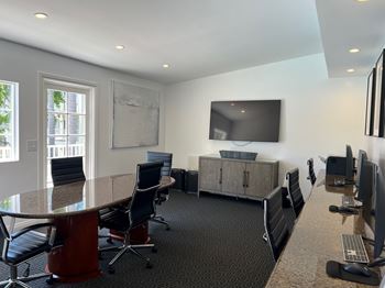 A conference room with a long table and chairs.